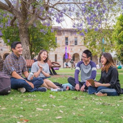 Group of students sit in UQ Great Court.